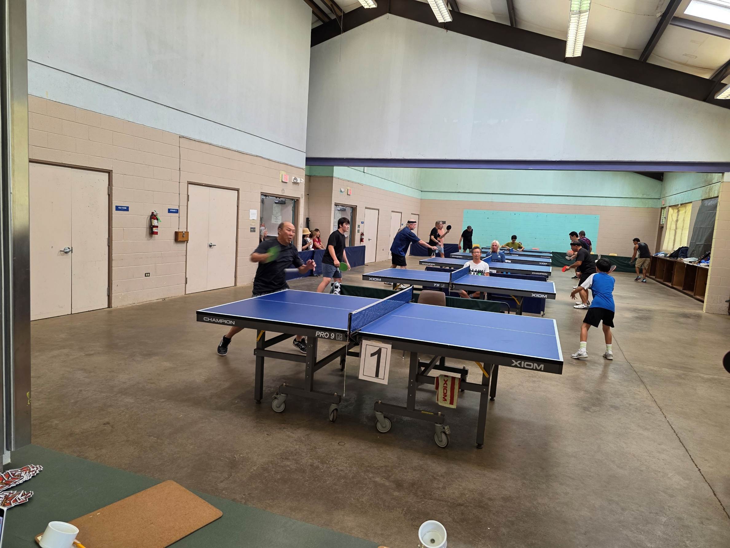 A group of people playing ping pong

AI-generated content may be incorrect.