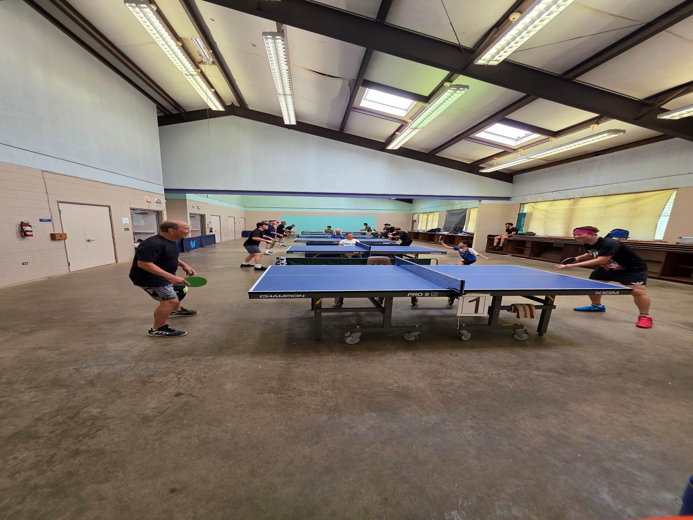 A group of people playing ping pong

AI-generated content may be incorrect.
